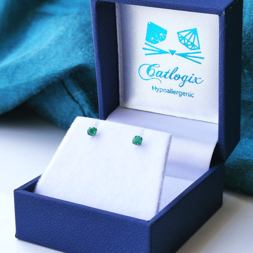 titanium emerald earrings in a box