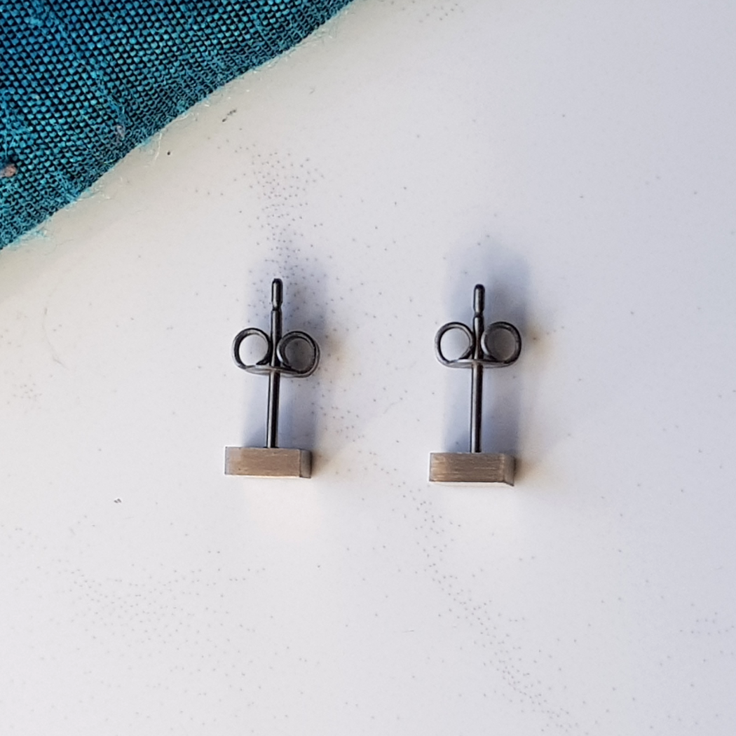 geometric square titanium stud earrings top view